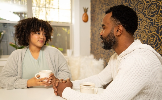 Two people talking together at a table