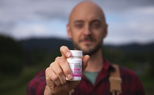 Man holding medication bottle