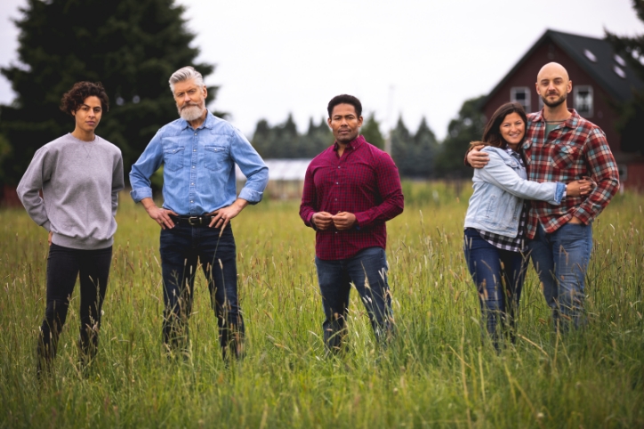 Five happy people in rural Oregon standing in a field together