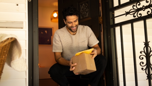 Man picking up packages from his front door