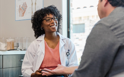 Female black doctor talking to a patient