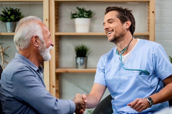 doctor shaking hands with an older patient