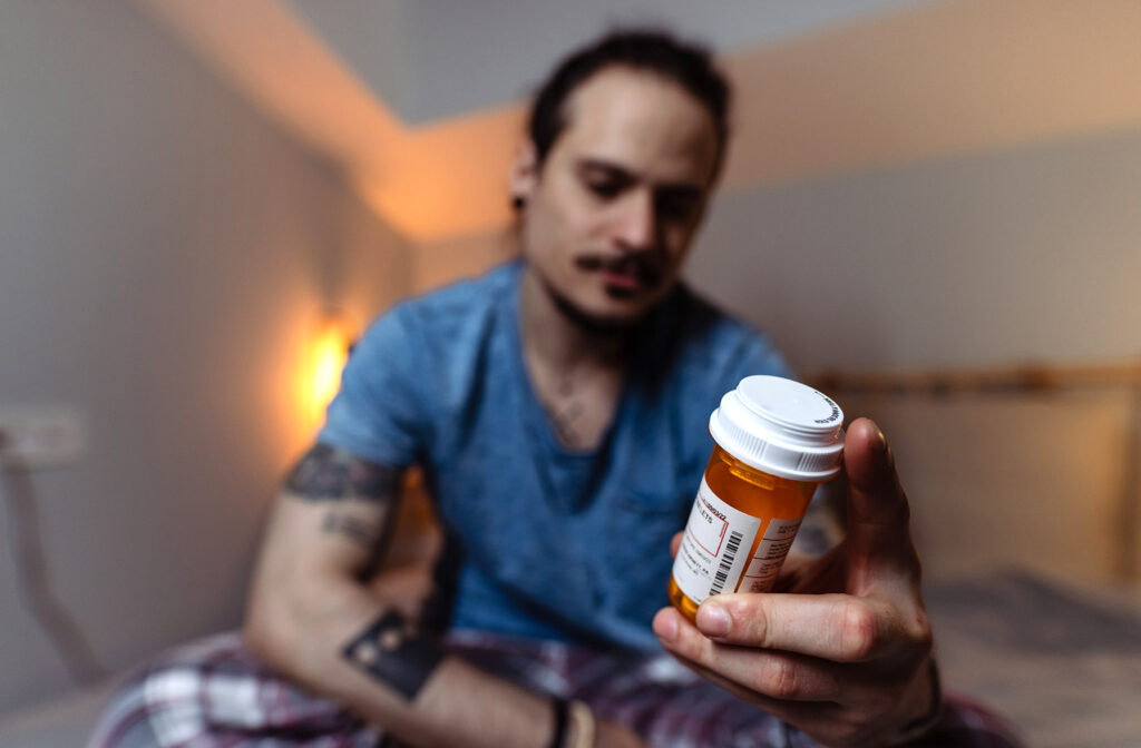 Man holding a PEP pill bottle