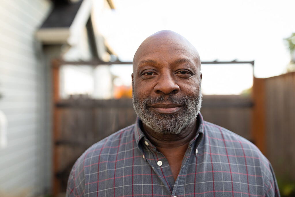 Portrait of a black man in an outdoor setting.